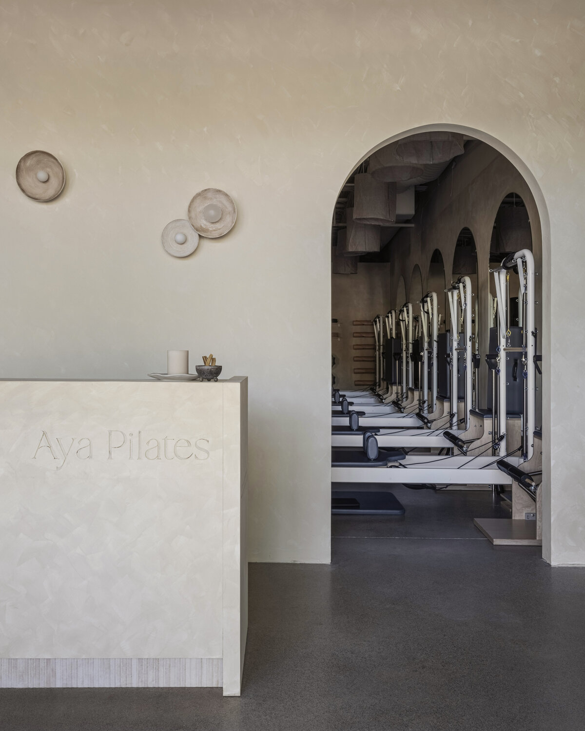 Aya Pilates reception with an arched entrance to the reformer studio