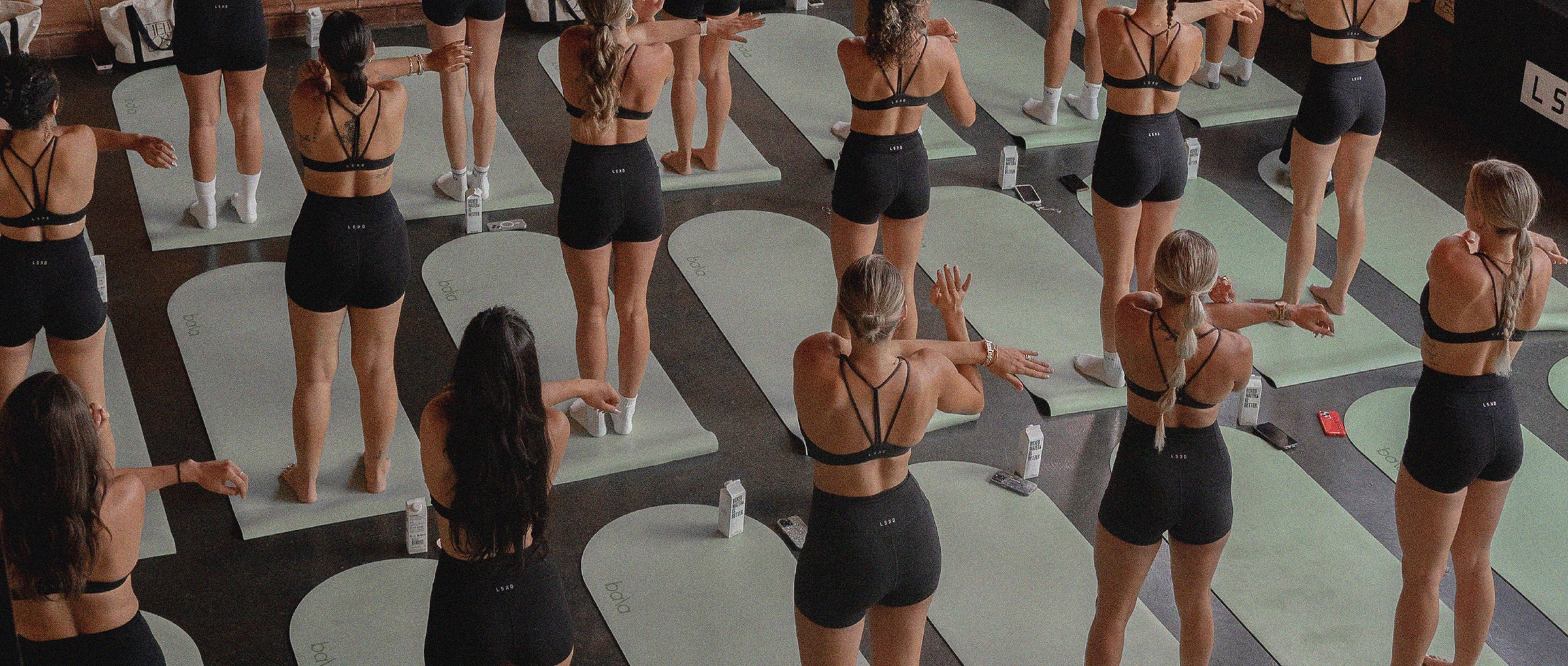 A community movement class with participants exercising on mats