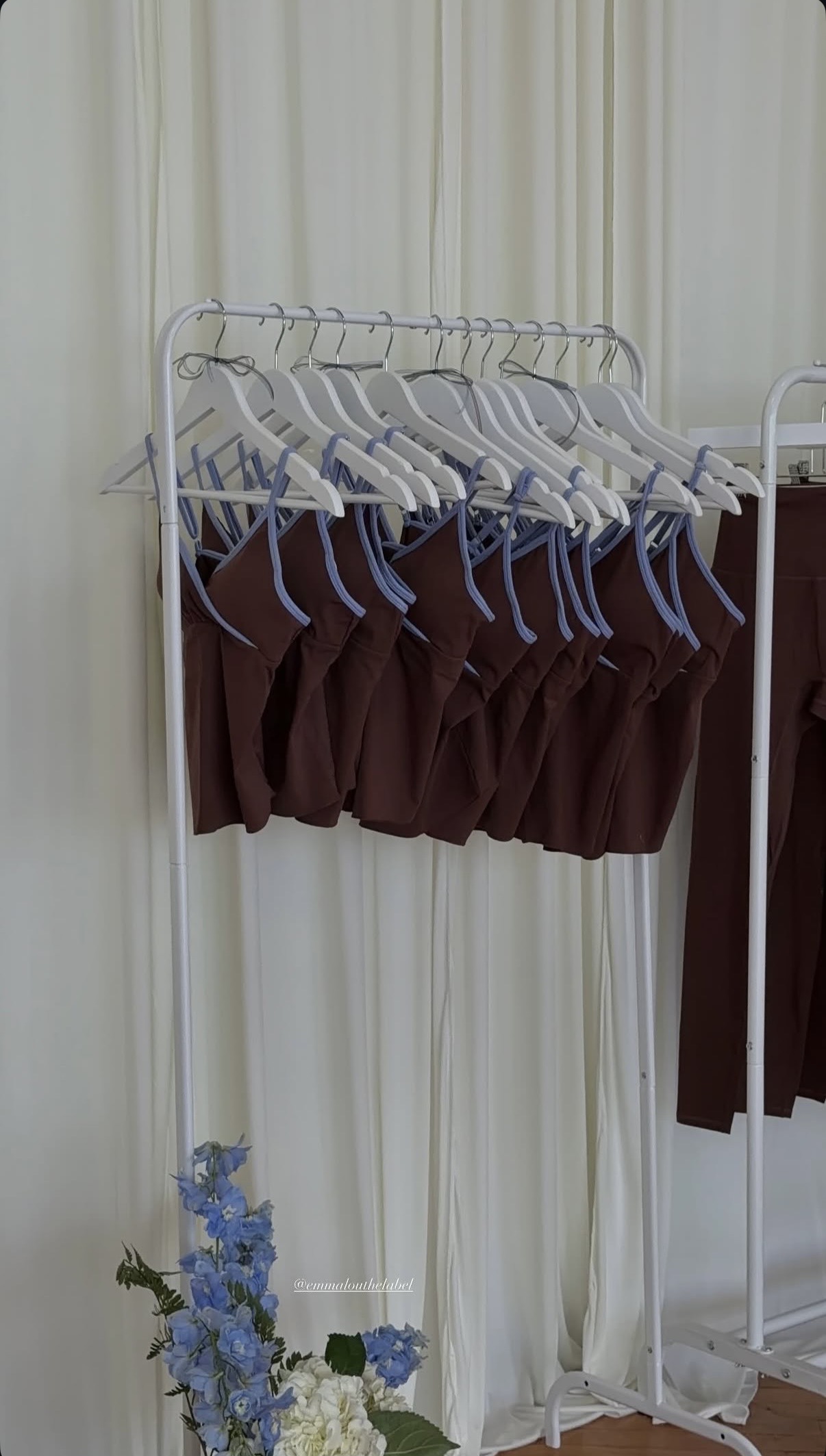 Activewear displayed on a rack with blue and white flowers