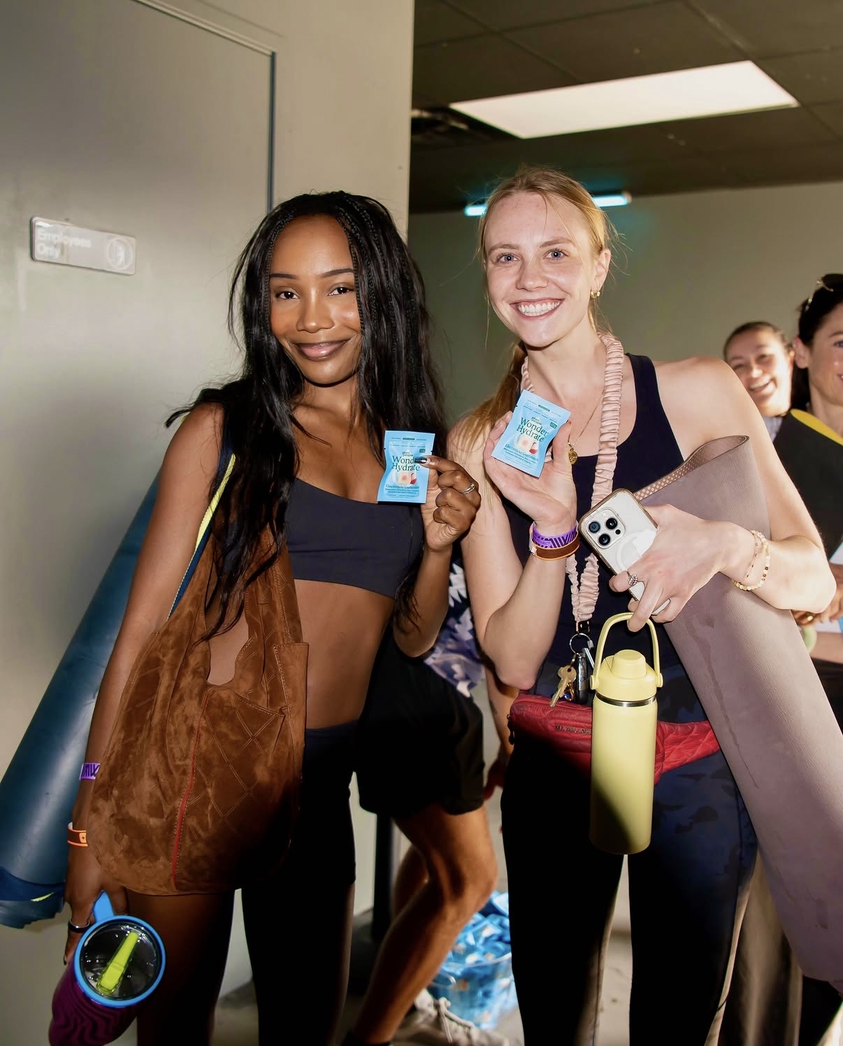 Two studio visitors holding Wonder Hydrate samples